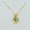 Jewelry store in Boston gold necklace with diamonds and bleu center stone